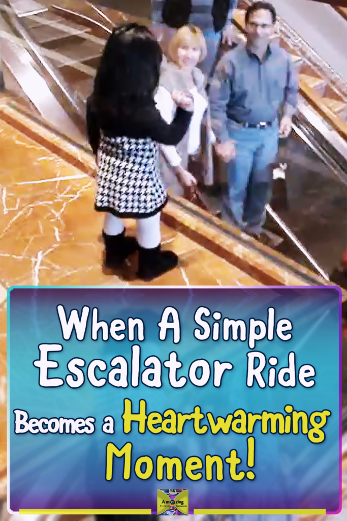A little girl stands beside an escalator at a shopping mall, waving and saying bye to people as they ride past while adults smile and wave back.
