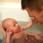 Newborn Baby takes his first bath