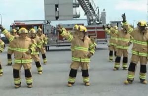 Stayin' Alive, Firefighters, Flashmob Dance, CPR, Chest Compressions, Heart Health, Bee Gees, Public Awareness, Educational, Entertainment, Fun, Engagement, Firefighter Gear, Props, Popular Culture, TV Shows, Ellen Show, America's Got Talent, Stayin' Alive, firefighter flashmob dance, CPR awareness, heart health awareness, Bee Gees, chest compressions, public health awareness, fire department, first responders, pop culture, TV appearances, unique dance routine, engaging education, life-saving skills, public safety awareness