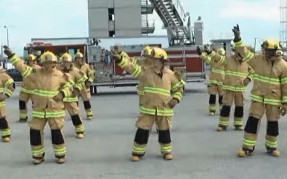 Stayin' Alive, Firefighters, Flashmob Dance, CPR, Chest Compressions, Heart Health, Bee Gees, Public Awareness, Educational, Entertainment, Fun, Engagement, Firefighter Gear, Props, Popular Culture, TV Shows, Ellen Show, America's Got Talent, Stayin' Alive, firefighter flashmob dance, CPR awareness, heart health awareness, Bee Gees, chest compressions, public health awareness, fire department, first responders, pop culture, TV appearances, unique dance routine, engaging education, life-saving skills, public safety awareness