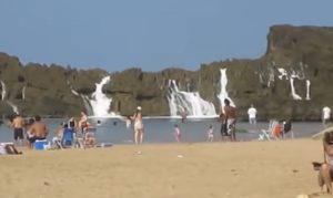Puerto Nuevo Beach, Vega Baja, Craggy rock formation, Serene lagoon, Pristine shoreline, Natural wonders, Protective barrier, Hidden gem, Land and sea, Perfect getaway.