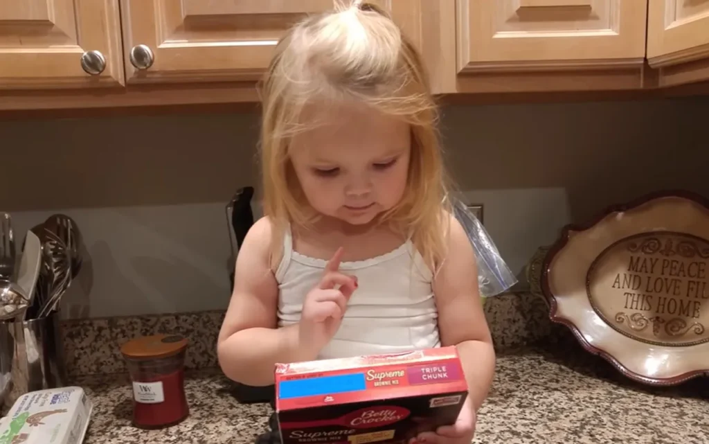 3-year-old guides dad baking, Betty Crocker brownies tutorial, funny brownie baking video, hilarious baking with kids, viral kid baking video, dad and daughter cooking moment, chaotic kitchen adventure, child baking instructions, funny family baking stories, baking with toddlers