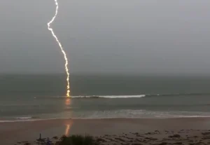 slow-motion lightning footage, slow-motion lightning, lightning strike video, Florida lightning, beach lightning strike, nature footage, slow-motion nature, lightning over water, dramatic lightning, lightning photography, nature's power, slow-motion beach