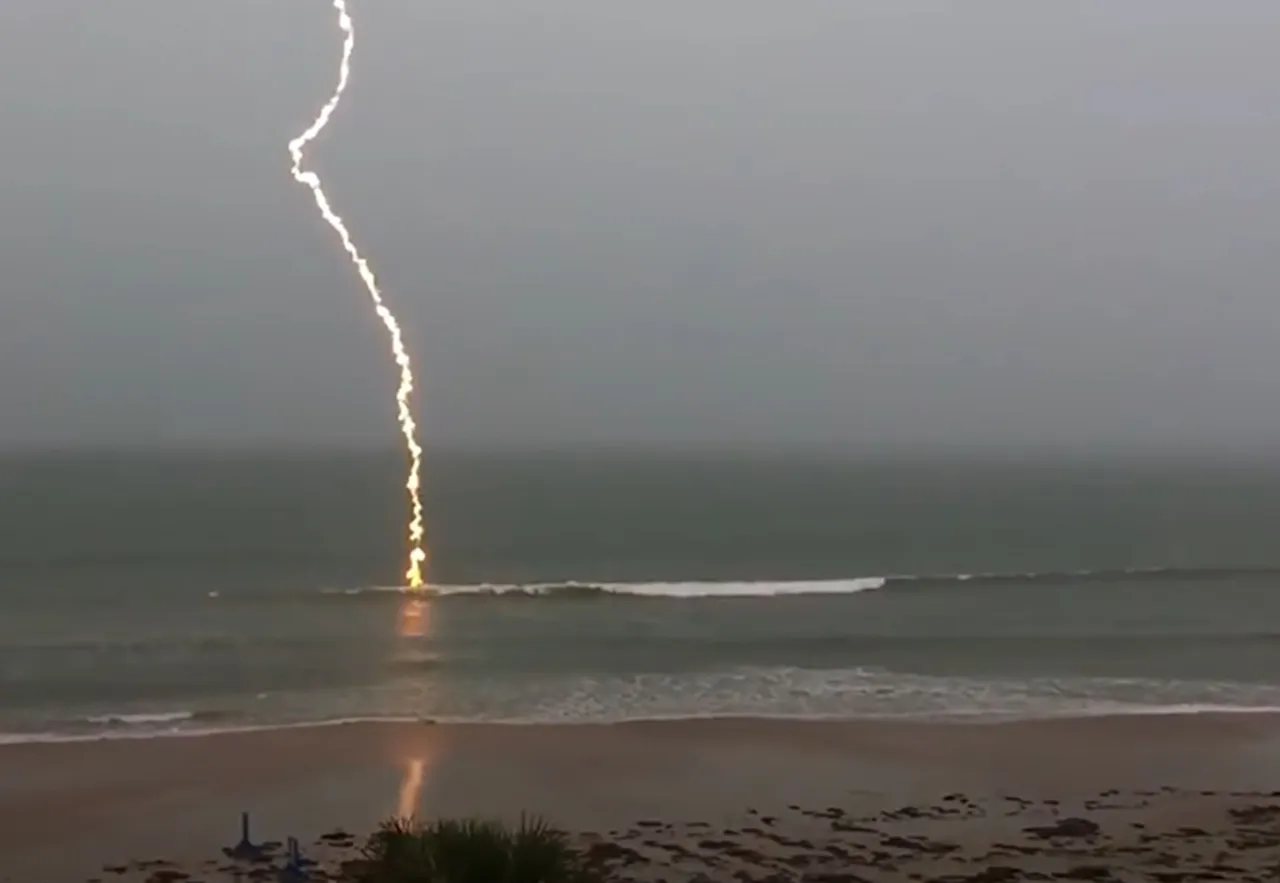 slow-motion lightning footage, slow-motion lightning, lightning strike video, Florida lightning, beach lightning strike, nature footage, slow-motion nature, lightning over water, dramatic lightning, lightning photography, nature's power, slow-motion beach