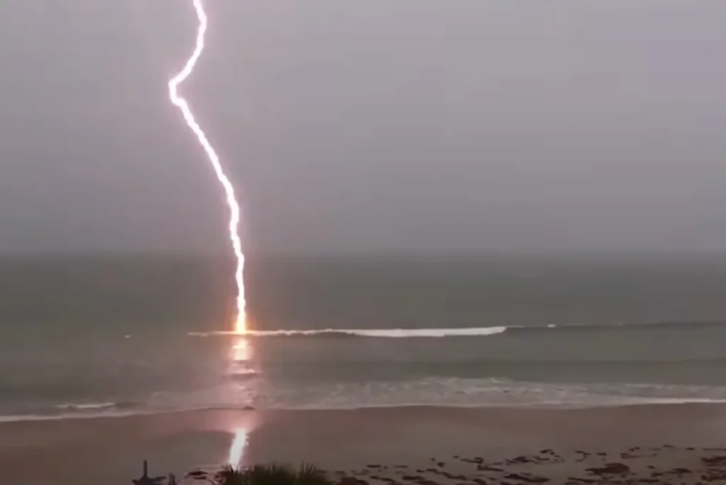 slow-motion lightning footage, slow-motion lightning, lightning strike video, Florida lightning, beach lightning strike, nature footage, slow-motion nature, lightning over water, dramatic lightning, lightning photography, nature's power, slow-motion beach