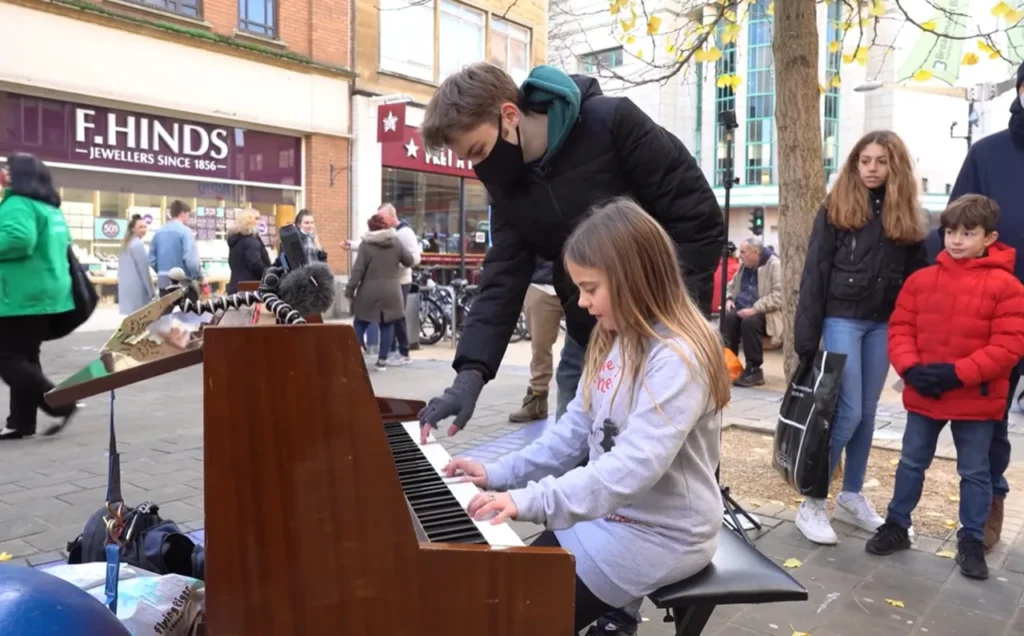 street performance, public piano, overcoming stage fright, Joe Jenkins, young pianist, street pianist, building confidence, calming techniques, street crowd, music performance, breathing exercises, visualization, managing nerves, YouTube pianist, piano performance