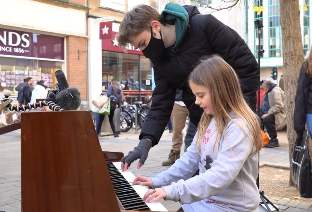 street performance, public piano, overcoming stage fright, Joe Jenkins, young pianist, street pianist, building confidence, calming techniques, street crowd, music performance, breathing exercises, visualization, managing nerves, YouTube pianist, piano performance