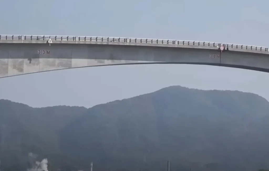 Eshima Ohashi Bridge, roller-coaster bridge, Japan's largest rigid-frame bridge, steep incline bridge in Japan, thrilling bridge experience, Eshima Ohashi tourist attraction, Shimane Prefecture bridge, Tottori Prefecture bridge, engineering marvel in Japan, Japan's roller-coaster bridge design