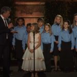 The young girl in the center begins to sing