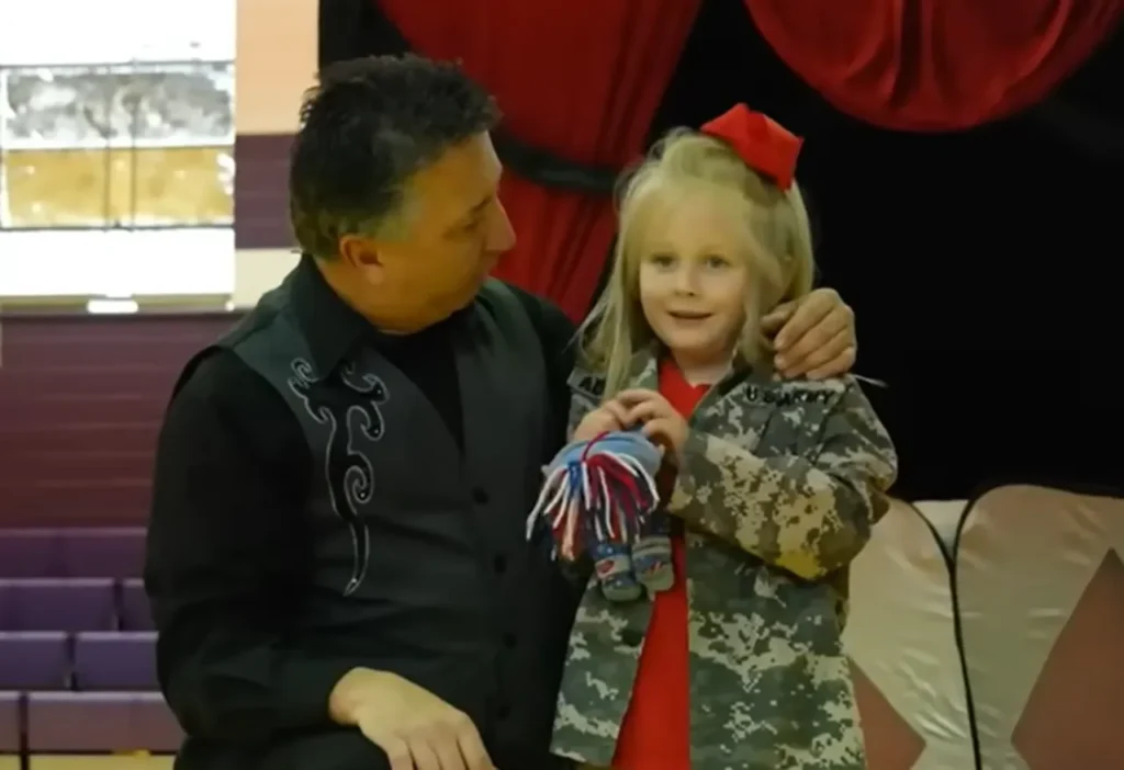 Military family reunion, School magic show surprise, Emotional reunion, Military sacrifices, Soldiers surprise daughter, Heartwarming moment, Tearful reunion, Surprise at school, Reunited family, Joyful homecoming