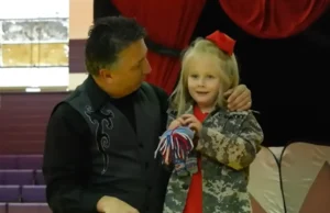 Military family reunion, School magic show surprise, Emotional reunion, Military sacrifices, Soldiers surprise daughter, Heartwarming moment, Tearful reunion, Surprise at school, Reunited family, Joyful homecoming