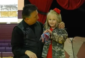 Military family reunion, School magic show surprise, Emotional reunion, Military sacrifices, Soldiers surprise daughter, Heartwarming moment, Tearful reunion, Surprise at school, Reunited family, Joyful homecoming