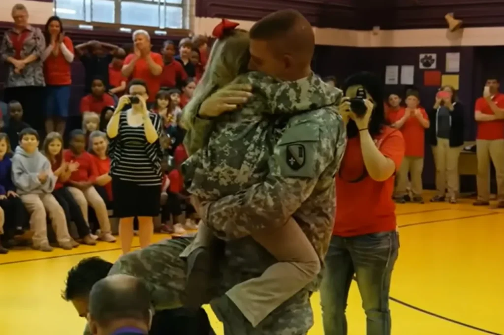 Military family reunion, School magic show surprise, Emotional reunion, Military sacrifices, Soldiers surprise daughter, Heartwarming moment, Tearful reunion, Surprise at school, Reunited family, Joyful homecoming