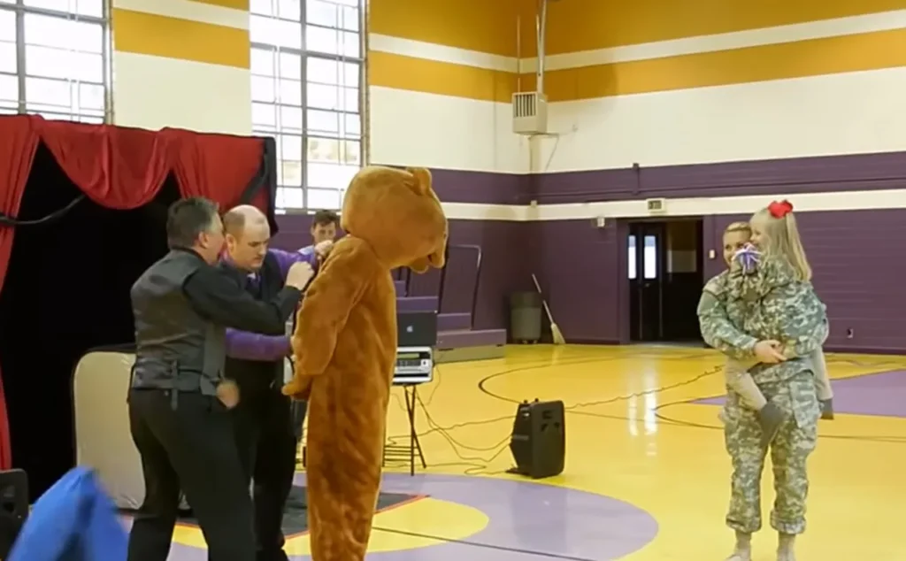 Military family reunion, School magic show surprise, Emotional reunion, Military sacrifices, Soldiers surprise daughter, Heartwarming moment, Tearful reunion, Surprise at school, Reunited family, Joyful homecoming