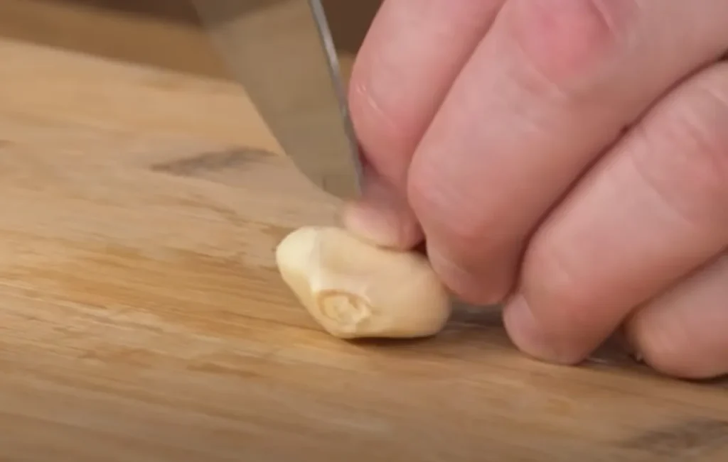 peeling garlic, garlic techniques, garlic preparation, garlic tips, cooking garlic, garlic methods, garlic slicing, garlic crushing, garlic chopping, roasted garlic