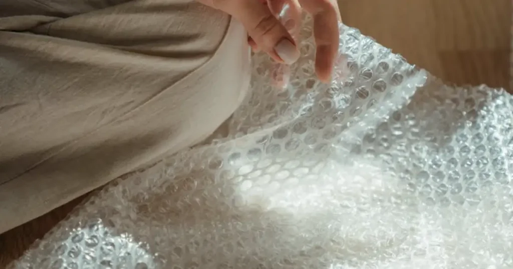 bubble wrap junk journal, DIY fabric-covered journal, upcycled bubble wrap craft, handmade junk journal, soft cover journal DIY, eco-friendly journal project, recycled bubble wrap journal, junk journaling ideas, DIY stationery from waste, sustainable upcycled crafts