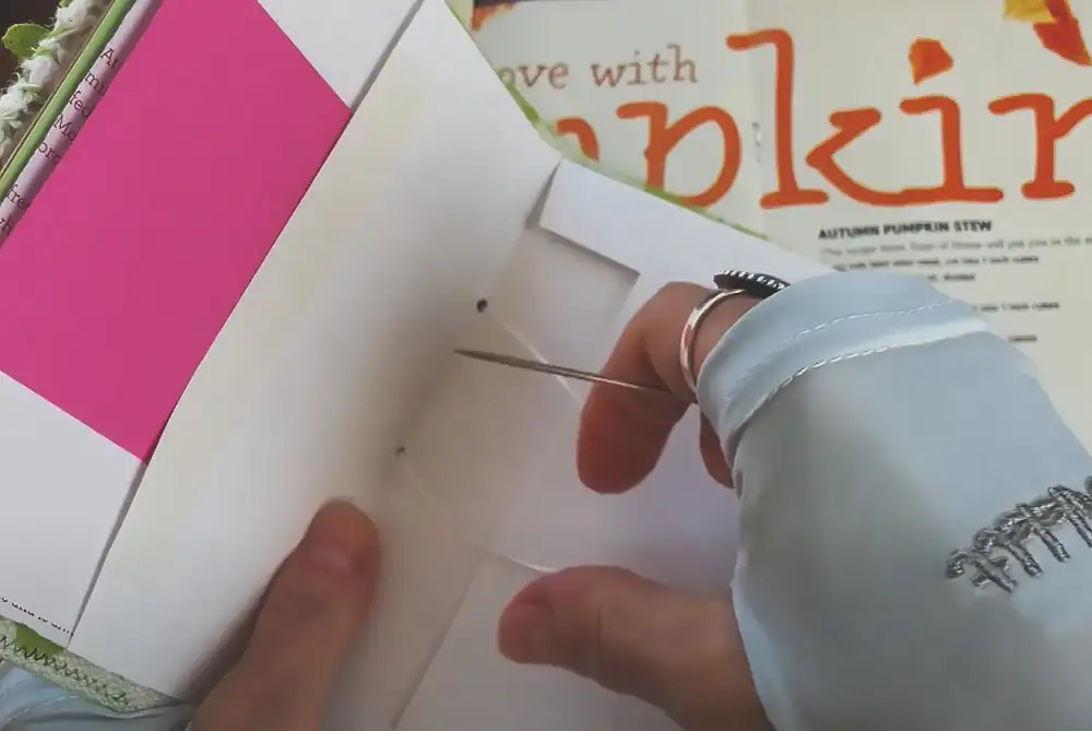 Punch holes through signatures and cover spine. Use ribbon or waxed thread for a pamphlet stitch. Beginner alternative: Bind with metal rings.