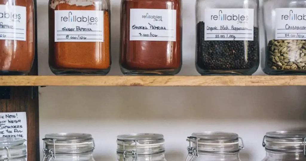 Organizing pantry with clear storage bins for visibility