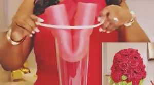 A DIY wedding centerpiece made from a pool noodle and floral materials, styled to look elegant and high end for wedding table decor.