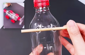 A handmade toy car built from a recycled plastic bottle with wheels and a propeller, shown as an easy DIY craft idea for kids, home projects, or school science activities.