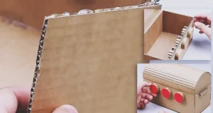 A handmade cardboard treasure chest with a curved lid and a working 3-digit combination lock, shown as a creative DIY craft project for making a secret storage box at home.
