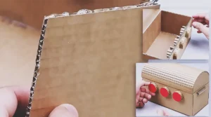 A handmade cardboard treasure chest with a curved lid and a working 3-digit combination lock, shown as a creative DIY craft project for making a secret storage box at home.