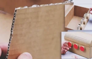 A handmade cardboard treasure chest with a curved lid and a working 3-digit combination lock, shown as a creative DIY craft project for making a secret storage box at home.