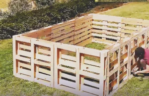 A DIY backyard pool project made from old wooden pallets, showing an upcycled outdoor build that transforms discarded materials into a creative summer pool idea.