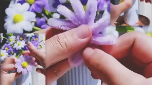 A DIY craft tutorial showing how to make decorative flowers from pipe cleaners for gifts, handmade decor, or easy floral projects.