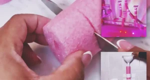A pink pool noodle bathtub water wall with white funnels taped to bathroom tiles above a colorful bath setup, creating a fun DIY glow bath play area for kids.