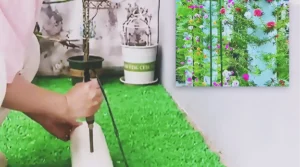A tall white PVC pipe planter filled with portulaca cuttings and colorful moss rose flowers, creating a vertical flower tower for a small balcony or patio garden.