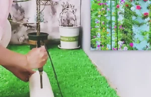 A tall white PVC pipe planter filled with portulaca cuttings and colorful moss rose flowers, creating a vertical flower tower for a small balcony or patio garden.