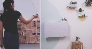 A pastel DIY Pinteresty wall with a large blue-green painted arch, small peach and yellow half-circle shelf backdrops, plants, floating shelves, and a white wall-mounted desk.