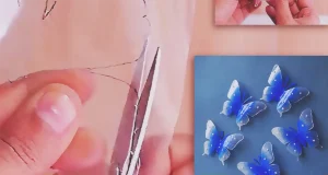 Blue and transparent butterflies made from recycled plastic bottles, decorated with pearl beads and displayed on a wall near a window as handmade DIY wall decor.