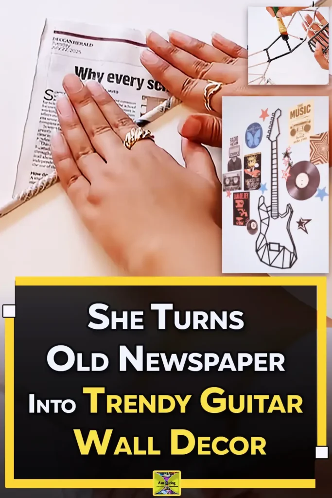 A handmade guitar wall decoration made from rolled newspaper sticks painted black and displayed on a music-themed wall with posters, records, and star accents.