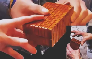 A skilled craftsman demonstrates an intricately carved wooden puzzle box with geometric details, concealed sliding panels, a hidden release mechanism, and a secret interior compartment.