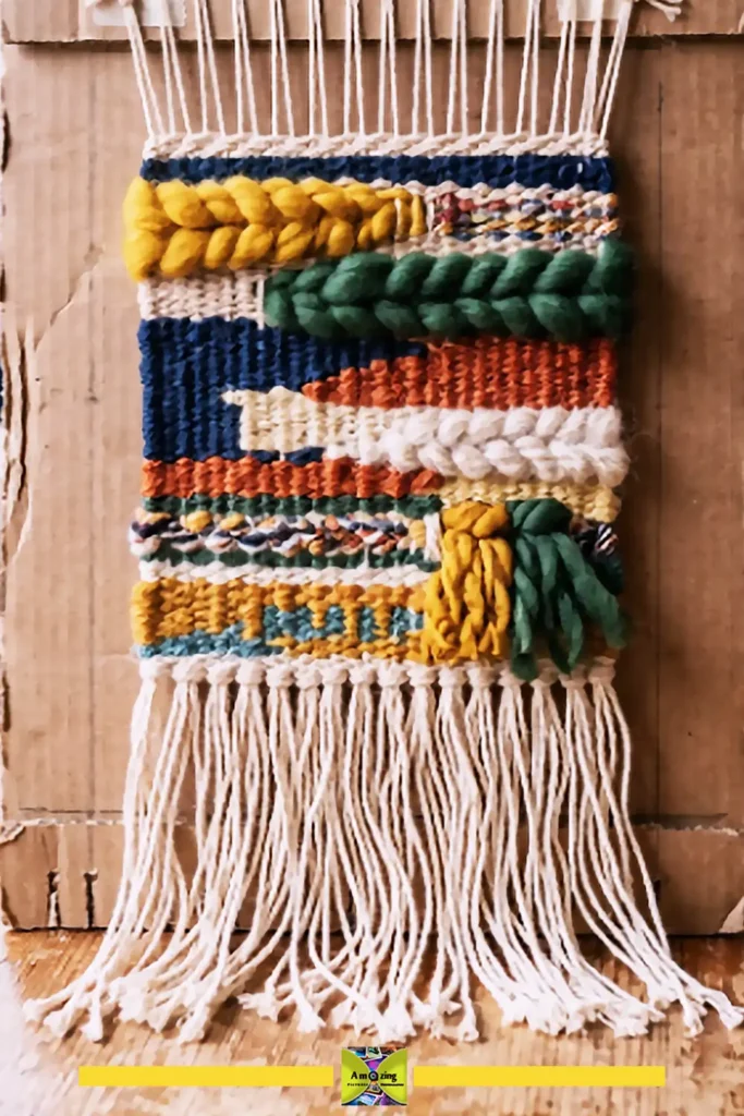 Finished woven wall hanging in cream, rust, and olive on a white wall