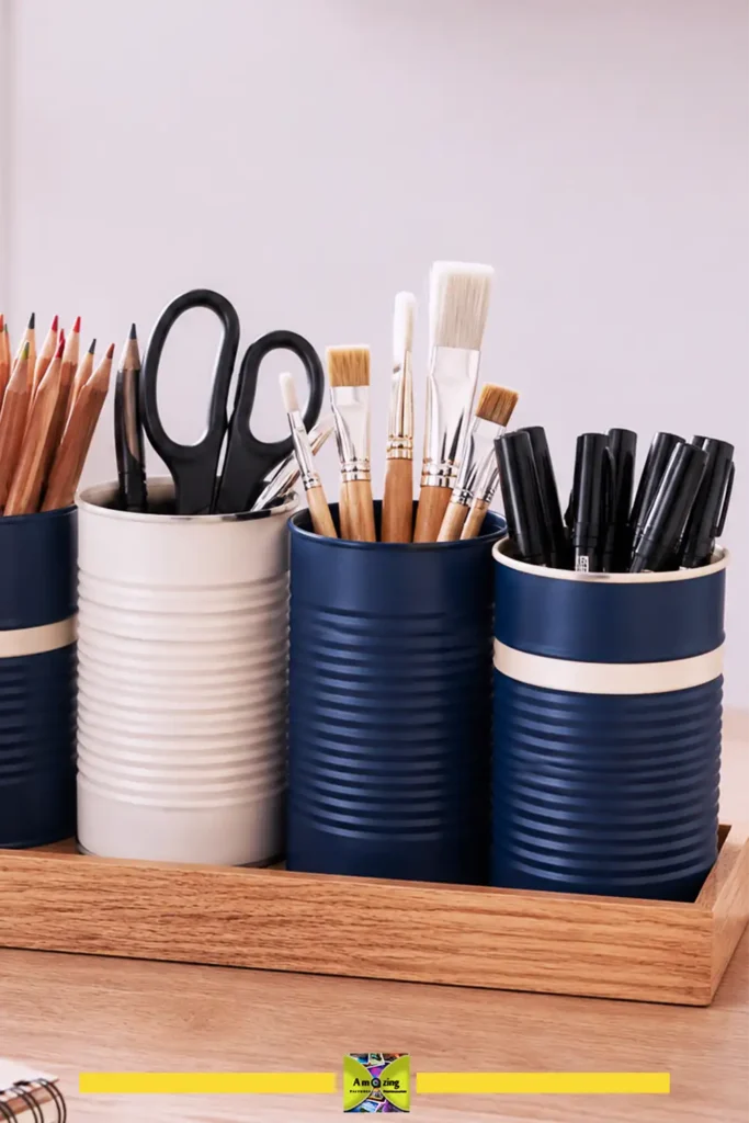 Set of coordinated painted tin cans used as desk supply cups holding pens and scissors