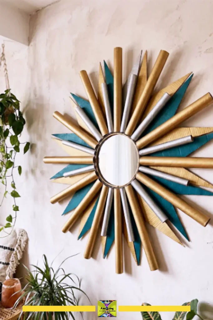 Gold-painted cardboard sunburst mirror frame on a pale gray wall