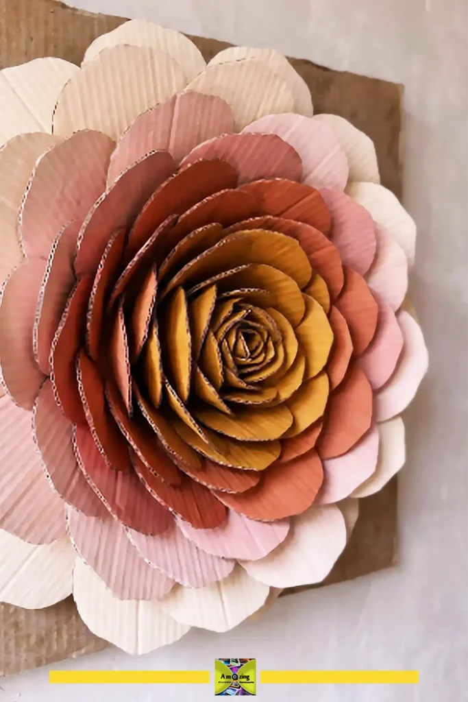 Finished layered cardboard flower wall art in soft coral and blush tones