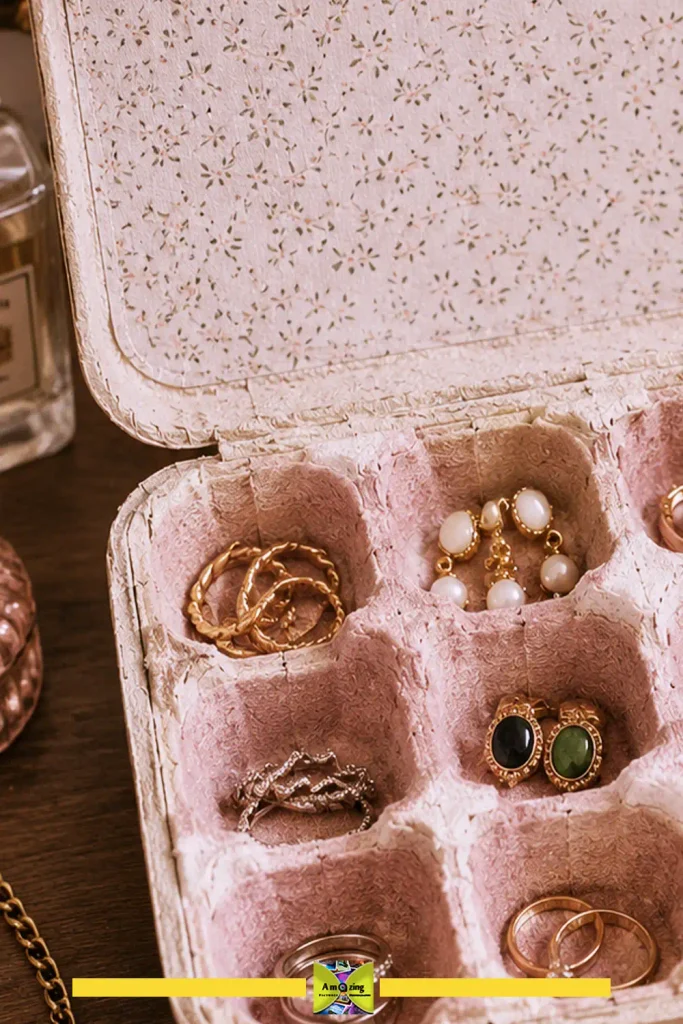 Egg carton box lined with fabric holding rings, earrings, and small jewelry