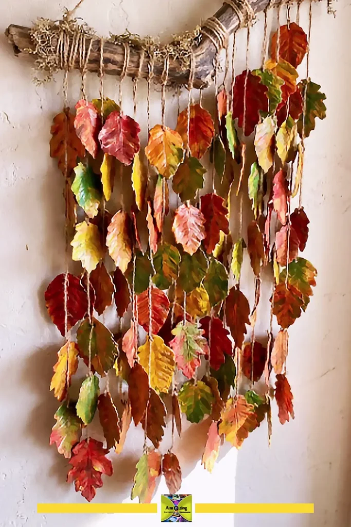 Green plastic bottle leaf wall hanging suspended from a natural branch