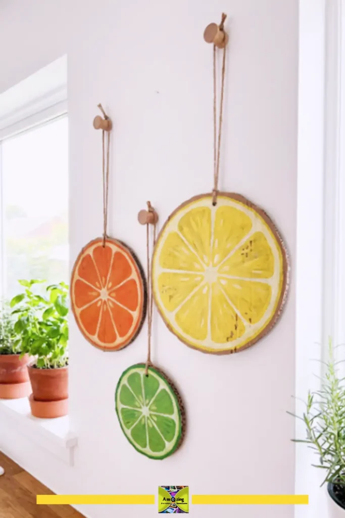 Set of three painted cardboard citrus slice wall decorations in lemon, lime, and orange