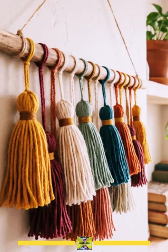 Multicolored yarn tassel wall hanging above a bed with boho bedding