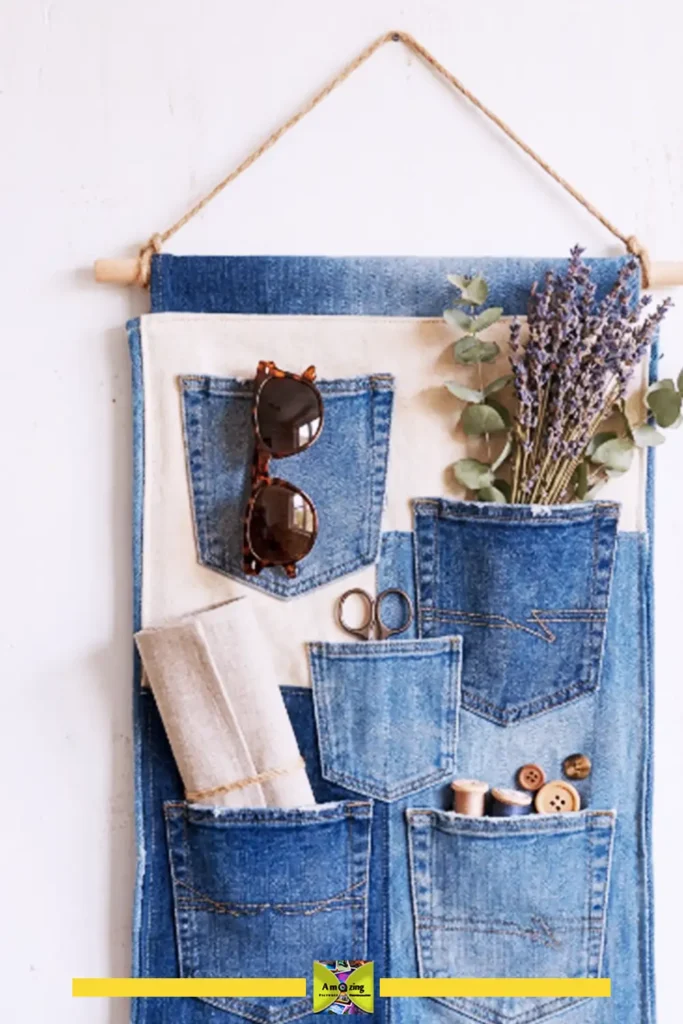 Denim pocket hanging organizer made from upcycled old jeans mounted on a wall