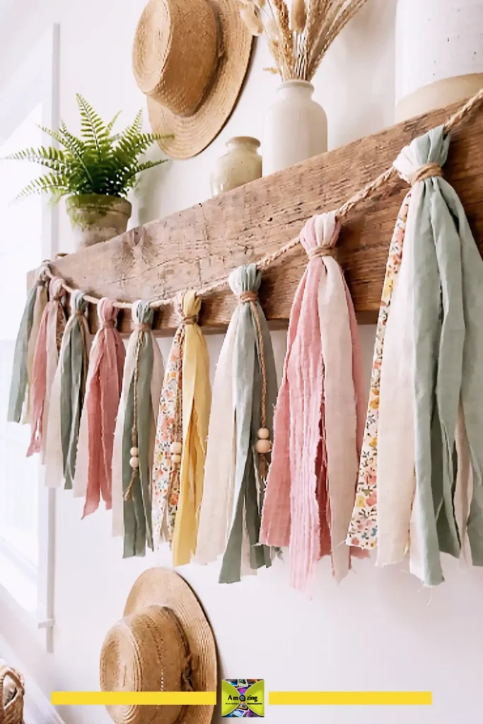 Fabric scrap summer tassel garland in sage and neutral tones strung along twine