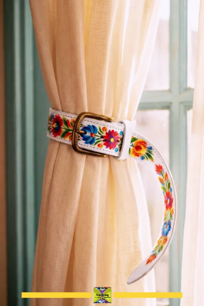 Cream curtain tied back with a white belt featuring vibrant floral patterns