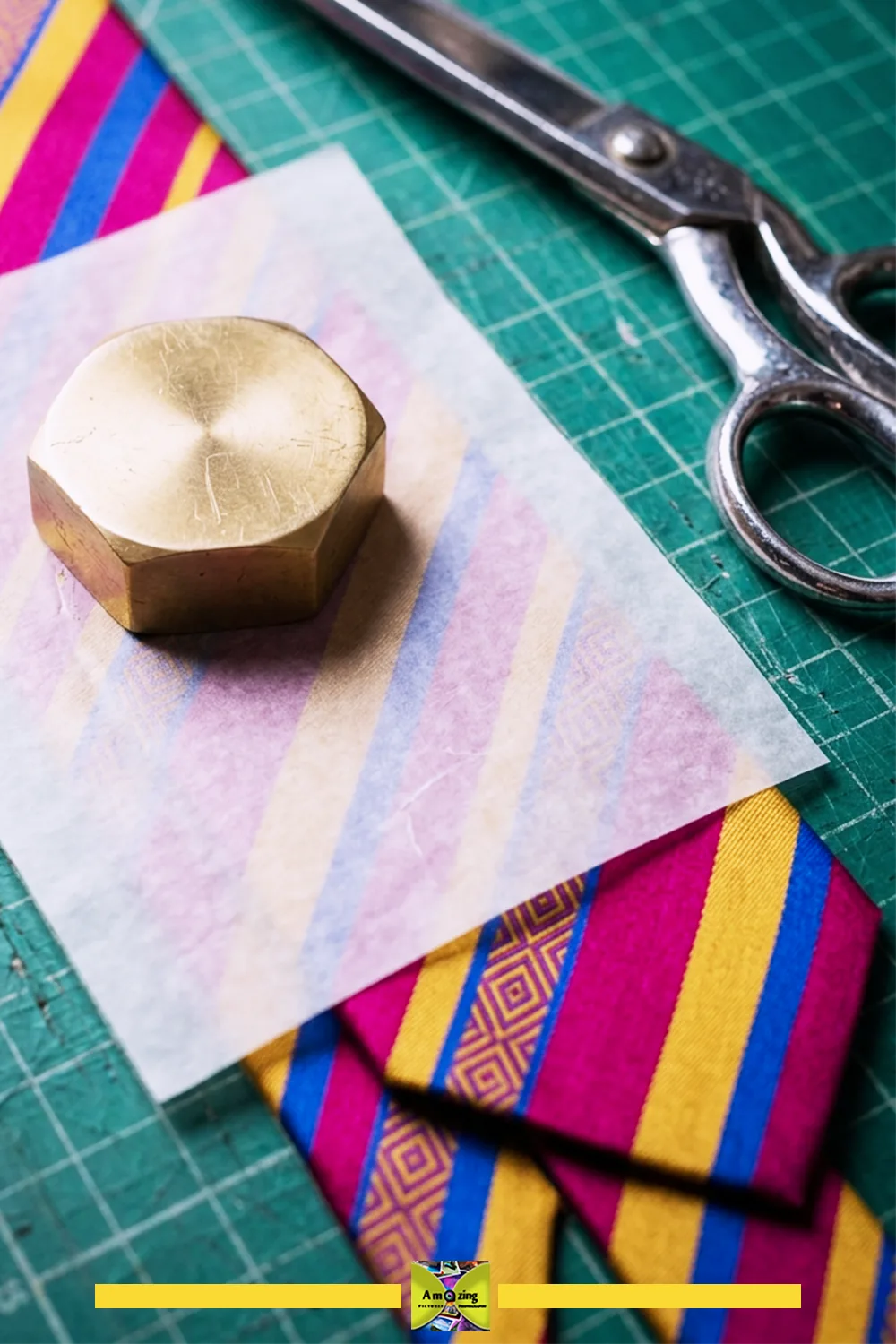 Paper pattern positioned on a narrow necktie panel with motif centering and a pattern weight in place