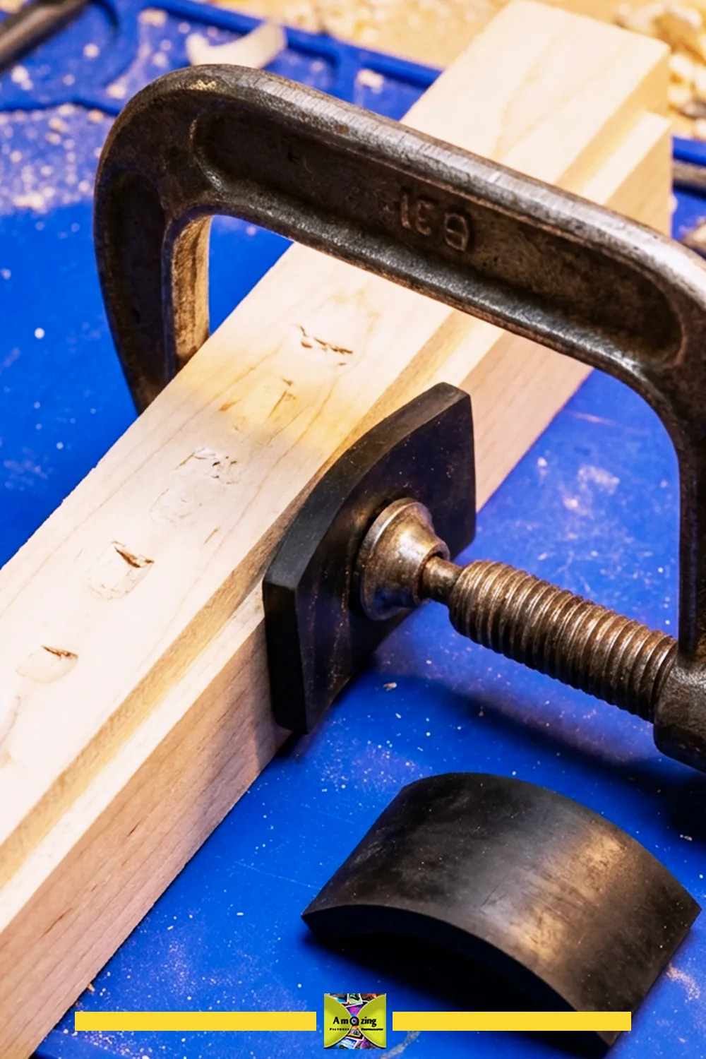 Black rubber clamp pad shaped to a specific clamp jaw, shown during a test