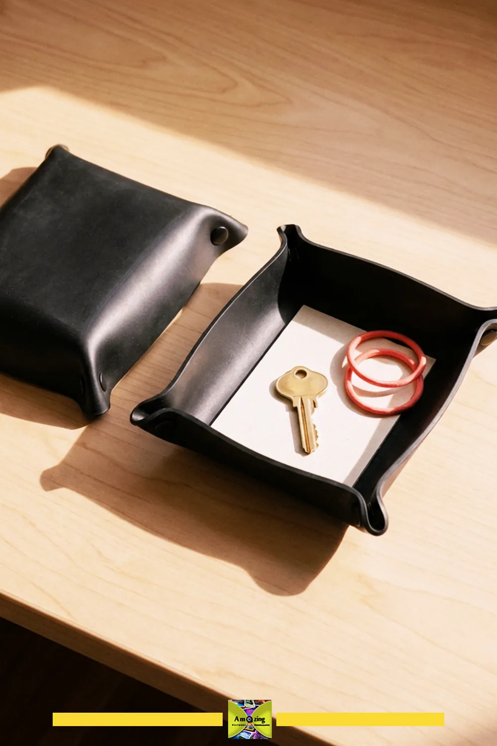 Black rubber desktop catchall tray shown flat and folded with the removable insert beside it